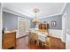 Bright dining room with hardwood floors, large window, and chandelier over the dining table at 3465 Summit Trl, Cumming, GA 30041
