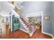 Elegant foyer with hardwood floors, staircase with iron railings, and view into the living room at 3465 Summit Trl, Cumming, GA 30041
