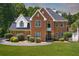 Classic brick home with manicured landscaping, a circular driveway, and timeless curb appeal at 3465 Summit Trl, Cumming, GA 30041