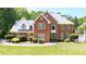 Beautiful two-story brick home featuring manicured landscaping and a welcoming front entrance at 3465 Summit Trl, Cumming, GA 30041