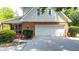 Attached two-car garage offers convenience and additional storage with a brick exterior for classic curb appeal at 3465 Summit Trl, Cumming, GA 30041
