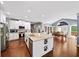 Bright kitchen with a central island, stainless steel appliances, and an adjacent dining area with large windows at 3465 Summit Trl, Cumming, GA 30041