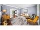 Inviting living room featuring hardwood floors, a cozy sofa, and a view into an adjacent room at 3465 Summit Trl, Cumming, GA 30041