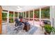 Serene sunroom features tile floors, abundant natural light, and views of the backyard and deck at 3465 Summit Trl, Cumming, GA 30041