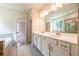 Bright bathroom featuring double vanity, and separate glass shower and tub at 3981 Adler Cir, Buford, GA 30519