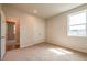 A carpeted bedroom features a double closet and a bright window, offering ample storage and natural light at 3981 Adler Cir, Buford, GA 30519