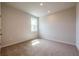 Bright bedroom with neutral carpet, a window letting in natural light, and a minimalist aesthetic at 3981 Adler Cir, Buford, GA 30519