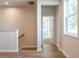 Hallway featuring wood floors, natural light, and an open doorway to another room at 3981 Adler Cir, Buford, GA 30519