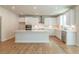 Bright kitchen boasts white cabinetry, stainless appliances, and an oversized island at 3981 Adler Cir, Buford, GA 30519