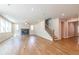Bright living room featuring wood floors, a modern fireplace, and views of the staircase at 3981 Adler Cir, Buford, GA 30519