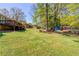 Expansive backyard with lush lawn, mature trees, and a detached shed for extra storage at 4048 Suzanne Ln, Duluth, GA 30096