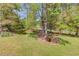 Large, green backyard with mature trees and landscaping, ideal for outdoor activities at 4048 Suzanne Ln, Duluth, GA 30096