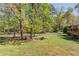 Spacious backyard with mature trees and landscaping, creating a private outdoor oasis at 4048 Suzanne Ln, Duluth, GA 30096