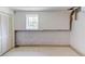 Unfinished basement area with white walls, a window, and white floors at 4048 Suzanne Ln, Duluth, GA 30096