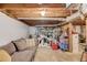 Unfinished basement with couch and visible ceiling, offering potential storage or living space at 4048 Suzanne Ln, Duluth, GA 30096