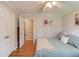Comfortable bedroom with hardwood floors and an open doorway to the next room at 4048 Suzanne Ln, Duluth, GA 30096