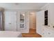 Light-filled bedroom with hardwood floors, white trim, and walk-in closet at 4048 Suzanne Ln, Duluth, GA 30096