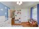 Playful room featuring blue accent wall with cloud details and hardwood floors at 4048 Suzanne Ln, Duluth, GA 30096