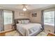 Primary bedroom with large windows and a gray upholstered bed at 4048 Suzanne Ln, Duluth, GA 30096
