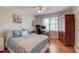 Cozy bedroom featuring hardwood floors, a ceiling fan, and a desk area for work or study at 4048 Suzanne Ln, Duluth, GA 30096