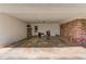 Spacious covered carport with storage shelving, brick accent wall and access to backyard at 4048 Suzanne Ln, Duluth, GA 30096