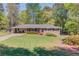 Charming one-story brick home with well-maintained lawn and a covered two car carport at 4048 Suzanne Ln, Duluth, GA 30096