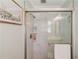 Modern tiled shower with glass door and shelves at 4048 Suzanne Ln, Duluth, GA 30096
