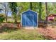 Exterior view of storage shed in backyard with mature landscaping and trees at 4048 Suzanne Ln, Duluth, GA 30096