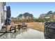 Large backyard with mature trees, a playset, and a patio with seating and grill at 4929 Dufour Dr, Lilburn, GA 30047