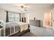 Bright primary bedroom features plush carpet, ample closet space and neutral wall paint at 4929 Dufour Dr, Lilburn, GA 30047