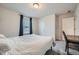 Well-lit bedroom with a bed, desk, and soft carpet, providing a comfortable living space at 4929 Dufour Dr, Lilburn, GA 30047