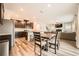 Open concept kitchen features stainless steel appliances, dark cabinetry, and an island with seating overlooking the dining area at 4929 Dufour Dr, Lilburn, GA 30047