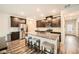 Modern kitchen with granite countertops, stainless steel appliances, dark cabinets, and an island with seating for three at 4929 Dufour Dr, Lilburn, GA 30047
