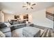 Open-concept living space featuring a large sofa, hardwood floors, and access to the kitchen at 4929 Dufour Dr, Lilburn, GA 30047