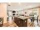Open concept living space with kitchen island, stainless steel appliances, dining area and living room fireplace at 4929 Dufour Dr, Lilburn, GA 30047