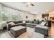 Spacious living room with an open floor plan, hardwood floors, and an oversized sectional sofa at 4929 Dufour Dr, Lilburn, GA 30047