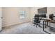 Well-lit office featuring neutral walls, carpet flooring, and a modern work setup with two monitors and a desk at 4929 Dufour Dr, Lilburn, GA 30047