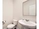 This cozy powder room features a pedestal sink, a toilet and neutral wall paint at 4929 Dufour Dr, Lilburn, GA 30047