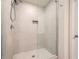 A bright bathroom features a walk-in shower with a glass door and neutral wall tile at 4929 Dufour Dr, Lilburn, GA 30047
