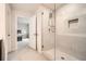 A bright bathroom features a walk-in shower with a glass door and neutral wall tile at 4929 Dufour Dr, Lilburn, GA 30047