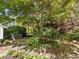 Secluded backyard featuring a stone patio and lush landscaping, offering a tranquil outdoor space at 7 Nesbit Pl, Alpharetta, GA 30022