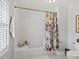 Bright white bathroom features a tub, white tile, and a floral shower curtain at 7 Nesbit Pl, Alpharetta, GA 30022