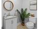 Stylish powder room with a modern vanity, decorative mirror, and a toilet at 7 Nesbit Pl, Alpharetta, GA 30022