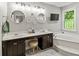 Bright bathroom with double sinks, vanity, a decorative window, and a soaking tub at 7 Nesbit Pl, Alpharetta, GA 30022