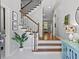 Welcoming home entryway with wooden stairs, a stylish console table, and charming decor at 7 Nesbit Pl, Alpharetta, GA 30022
