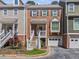 Charming brick townhome with inviting entryway and well-manicured landscaping at 7 Nesbit Pl, Alpharetta, GA 30022
