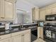 Kitchen with black appliances and sink with granite countertops and view to living space at 7 Nesbit Pl, Alpharetta, GA 30022