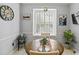 Bright eat-in kitchen with a window seat, a wood table and an accent wall art at 7 Nesbit Pl, Alpharetta, GA 30022