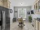 Eat-in kitchen featuring tile floors and a cozy breakfast nook with natural light at 7 Nesbit Pl, Alpharetta, GA 30022