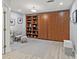 Spacious living area with built-in bookshelves, cabinets, a chair, and luxury vinyl floors at 7 Nesbit Pl, Alpharetta, GA 30022